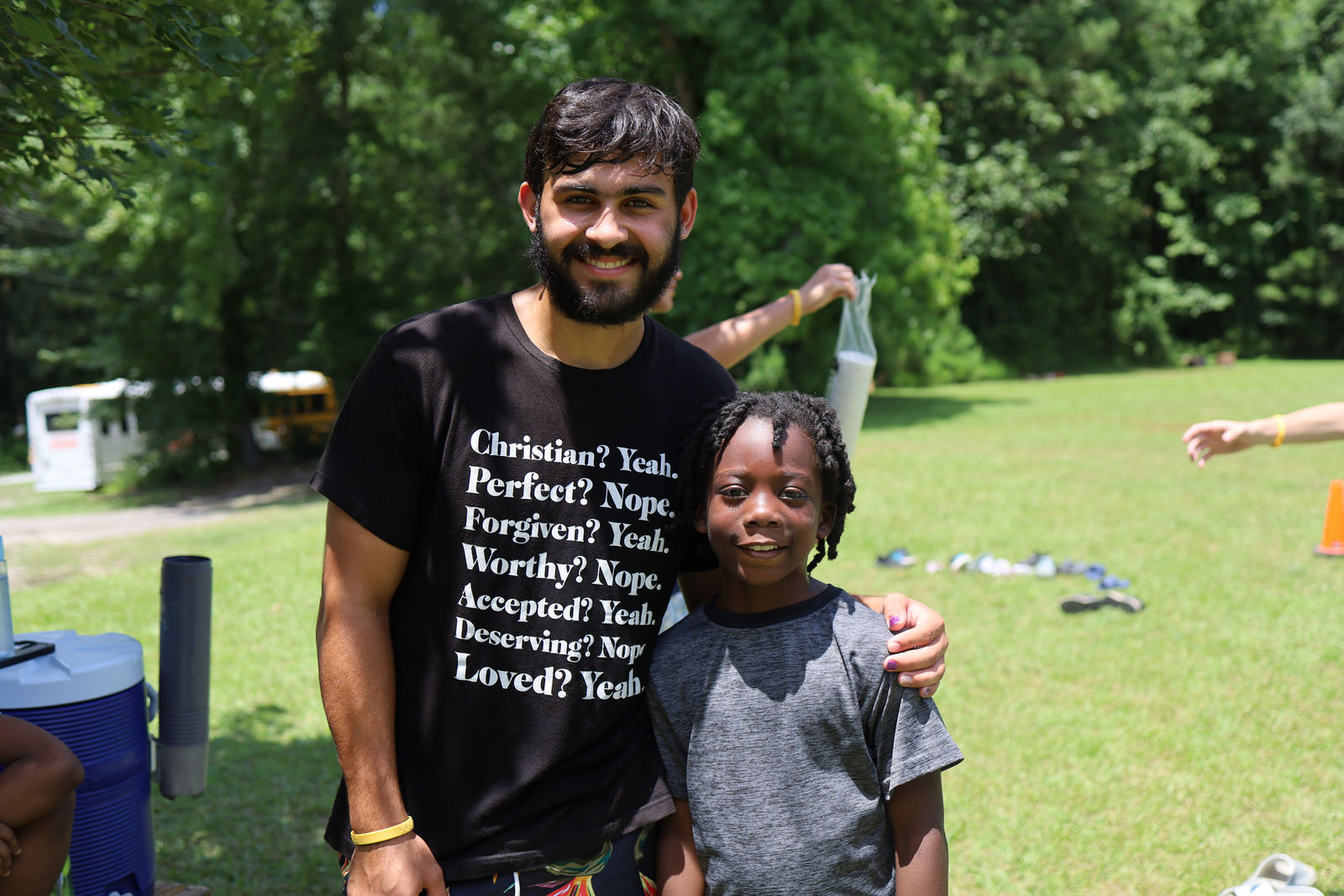 An AIM mentor with a child at summer camp